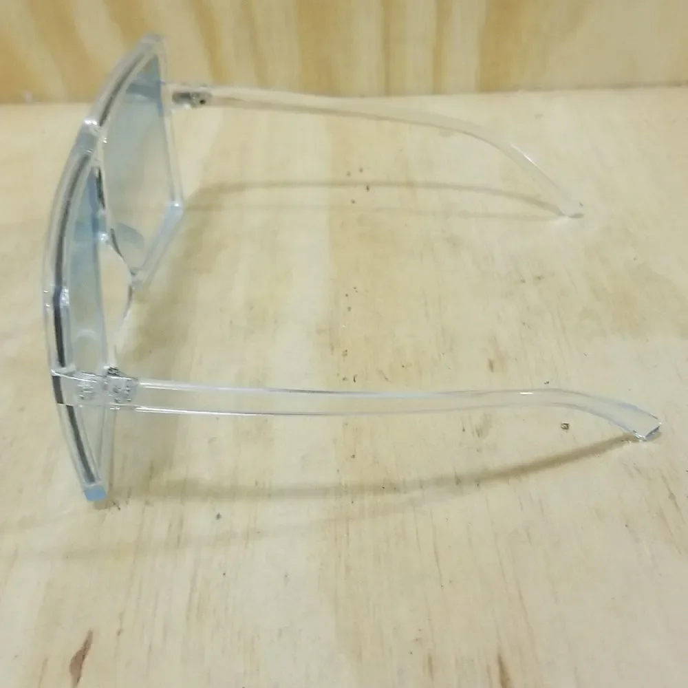 High Fashion Women's Sunglasses with clear frames/ blue tented lenses.